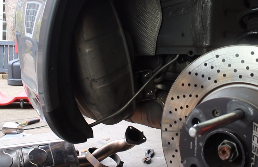 Next, start removing the side muffler.