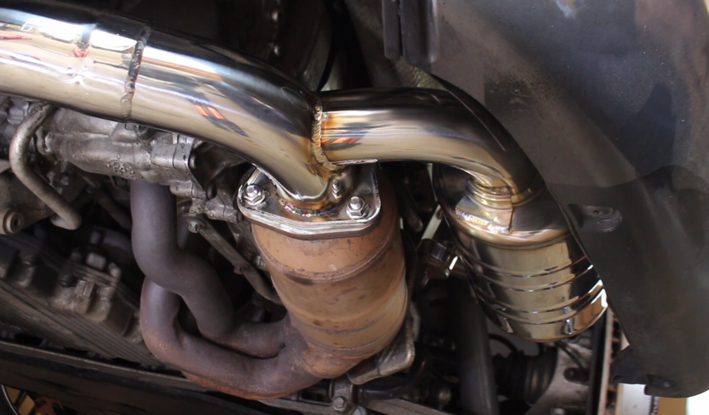 Install new exhaust gasket (PART LETTER) and secure new muffler to catalytic converter flange.